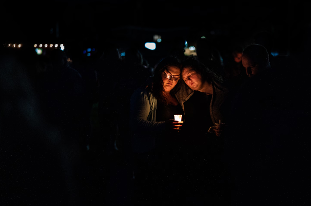 People gather for a vigil Saturday in Lisbon, Maine, days after a gunman killed 18 people in neighboring Lewiston. (Salwan Georges/The Washington Post)