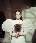Emma Stone in “Poor Things” in a wedding dress with sleeves like giant snowballs.Credit...Yorgos Lanthimos/Searchlight Pictures