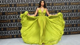Television host Padma Lakshmi arrives at the Emmys in a neon green goddess gown with gold bodice trimming by New York brand Marchesa. Aude Guerrucci/Reuters