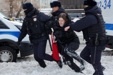 In Moscow, Russian police officers arrested a woman near the Wall of Grief, a monument to victims of political repression.Credit...Reuters