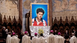 A tapestry featuring a portrait of Carlo Acutis is hung in the St. Francis Basilica in Assisi, Italy during his beatification ceremony on October 10, 2020. Vatican/Getty Images