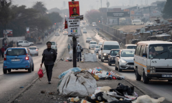 A woman walks past piles of uncollected trash in the township of Alexandra a day before the national election in Johannesburg. Photograph: Ihsaan Haffejee/Reuters