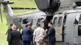 Ukrainian President Volodymyr Zelensky, centre, steps out of a Swiss Airforce helicopter after landing near the Bürgenstock Resort in Switzerland, ahead of a summit on peace in Ukraine, June 14, 2024. © Alessandro Della Valle, Reuters