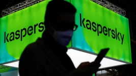 A man walks next to Russian Kaspersky stand during the GSMA's 2022 Mobile World Congress. © Albert Gea, Reuters