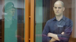 Wall Street Journal reporter Evan Gershkovich, who stands trial on spying charges, is seen inside an enclosure for defendants before a court hearing in Yekaterinburg, Russia, on Wednesday. (Evgenia Novozhenina/Reuters)