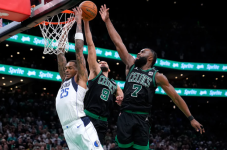 Mavericks forward P.J. Washington is blocked by the Celtics' Derrick White, center, as Jaylen Brown follows up late in the fourth quarter Sunday night in Boston. (Steven Senne/AP)