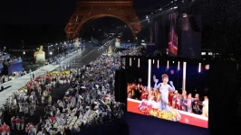 Delegations arrive at the Trocadero in Paris, as spectators watch French singer Philippe Katerine performing on a giant screen during the opening ceremony of the Paris 2024 Olympic Games on July 26. Ludovic Marin/Pool/Reuters