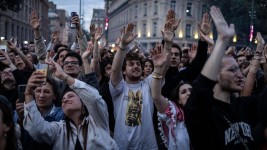 People celebrate during an election night rally following the first results of the second round of France's legislative election at Republique Square in Paris. Picture: Olympia De Maismont / AFP