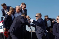 Former President Donald Trump is rushed offstage by U.S. Secret Service agents. ANNA MONEYMAKER/GETTY IMAGES