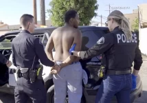 Newport Beach police officers take Leroy McCrary into custody in South Gate on July 2 after an attempted robbery resulted in the death of a tourist from New Zealand earlier in the day at Fashion Island. (OnScene.TV)