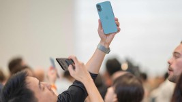 A man takes a photo of an iPhone 16 Pro following Apple's "It's Glowtime" event in Cupertino, California on September 9. Picture: AFP