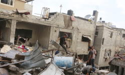 People search amid the ruins of a house hit by an Israeli airstrike at Nuseirat, Gaza, on Monday. Photograph: APAImages/Rex/Shutterstock