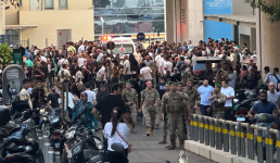 Lebanese soldiers, Hezbollah members and members of the public gather outside a hospital where injured people were being transported in Beirut. Photograph: Wael Hamzeh/EPA