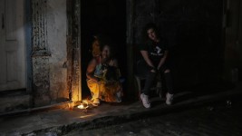 Residents pass the time during a blackout following the failure of a major power plant in Havana, Cuba on Saturday, Oct. 19, 2024. Ramon Espinosa/AP