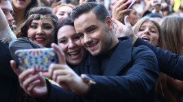 Liam Payne from One Direction takes a selfie with fans in 2014 in Sydney, Australia. Cameron Spencer/Getty Images