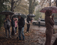 People brave torrential rain to collect packages of donated food in Kherson on Oct. 12. (Alice Martins for The Washington Post)