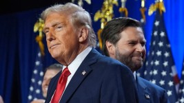 Republican presidential nominee former President Donald Trump and his running mate Sen. JD Vance, R-Ohio, stand on stage at an election night watch party, Nov. 6, 2024, in West Palm Beach, Fla. Evan Vucci/AP