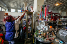 A worker earning minimum wages helps a customer at a thrift store in Los Angeles on 11 October 2024. Photograph: Damian Dovarganes/AP