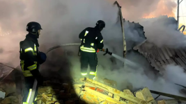 Ukrainian rescuers extinguish a fire at an energy infrastructure facility following a missile attack in Lutsk on November 28, 2024. © AFP handout photo, Ukrainian emergency services