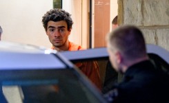 Luigi Mangione, the suspect in the killing of UnitedHealthcare CEO Brian Thompson, being led into a police car. Jeff Swensen/Getty Images