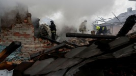 Firefighters work at the site of residential buildings hit by a Russian strike in Kharkiv, Ukraine, on December 25. Sofiia Gatilova/Reuters