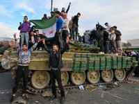 People celebrate with anti-government fighters at Umayyad Square in Damascus on Dec. 8, 2024. Islamist-led rebels declared that they have taken Damascus in a lightning offensive on Dec. 8, sending President Bashar al-Assad fleeing and ending five decades