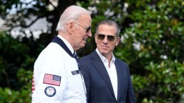 U.S. President Joe Biden, left, walks with his son Hunter on the South Lawn of the White House on July 26. (Susan Walsh/The Associated Press)