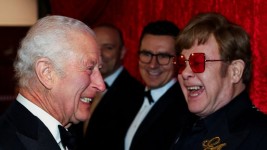 King Charles shares a laugh with Elton John at a Nov. 22 event at the Royal Albert Hall in London. (Toby Melville/Reuters)