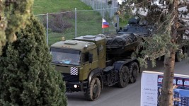 A Russian military vehicle heads towards Hmeimim air base in coastal Latakia, Syria on December 15. Umit Bektas/Reuters