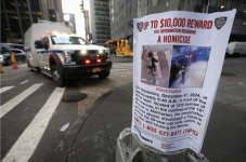 A poster seeking information on the killing of UnitedHealthcare CEO Brian Thompson near the scene in Midtown Manhattan where he was fatally shot. (Mike Segar/Reuters)