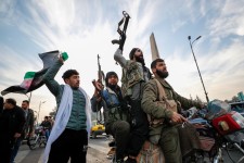 Syrian opposition fighters celebrate after the Syrian government collapsed in Damascus, Syria, Dec. 8, 2024. Omar Sanadiki/AP