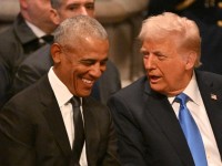 Obama laughs at something Trump said. (Photo by ROBERTO SCHMIDT / AFP)