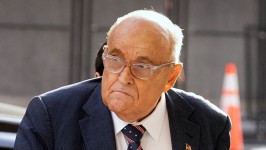 Rudy Giuliani, center, arrives at federal court in Washington, DC, on January 10.  Mark Schiefelbein/AP