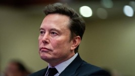 Tesla CEO and X owner Elon Musk, seen here listening to U.S. president-elect Donald Trump in Washington, D.C., on Nov. 13, 2024, has been lashing out at European politicians. (Allison Robbert/Reuters)