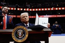 US President Donald Trump holds up an executive orders after signing it during an indoor inauguration parade at Capital One Arena on January 20, 2025, in Washington, DC. Getty Images