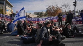 Activists representing families of Israelis who were killed during the war in Gaza block a road in Jerusalem during a protest against the ceasefire deal between Israel and Hamas on Thursday. (Ohad Zwigenberg/The Associated Press)