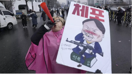 A protester blows a vuvuzela during a rally demanding the arrest of impeached South Korean President Yoon Suk Yeol in Seoul, South Korea on Monday, January 6, 2025. © Ahn Young-joon, AP