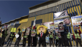 Des migrants et des défenseurs des droits de l'homme manifestent devant le mur qui sépare séparant le Mexique et les États-Unis, dimanche 19 janvier 2025, à Tijuana, au Mexique. AP - Gregory Bull