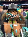 Kayla Nicole blows green and white confetti. Photo: Instagram, @iamkaylanicole.