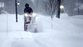 A person clears snow in Portsmouth, New Hampshire, Thursday.  Caleb Jones/AP