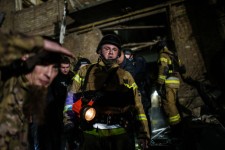 Rescue workers at a residential area in Kyiv targeted by Russian strikes.