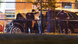 Police look over a black vehicle believed to be involved in what authorities are calling a "mass casualty" incident at the Lapu-Lapu Day street festival in Vancouver on April 26, 2025. (THE CANADIAN PRESS/Rich Lam)