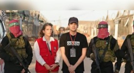 Israeli-American hostage Edan Alexander next to Hamas terrorists and a Red Cross employee, May 12, 2025. (photo credit: screenshot/Al Jazeera )