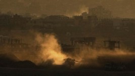 An Israeli army tank maneuvers in the Gaza Strip is seen from southern Israel on May 4. Ariel Schalit/AP