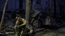 A file photo of a rescue worker resting near a university building destroyed by a Russian missile strike on Sumy, Ukraine, April 13, 2025. © Evgeniy Maloletka, AP