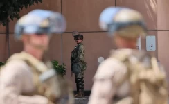 Marines frame a California National Guardsman stationed outside the federal detention center in downtown Los Angeles on Tuesday. (Allen J. Schaben / Los Angeles Times)