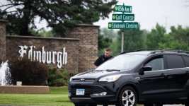 A Brooklyn Park police officer speaks with the driver of a vehicle entering a neighborhood on June 14, 2025, in Brooklyn Park, Minnesota. ( Stephen Maturen/Getty Images)