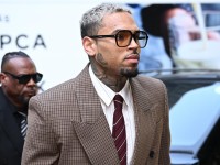 Chris Brown has arrived in court, accused of assaulting a music producer while flanked by a gaggle of adoring fans. Picture: Leon Neal/Getty Images