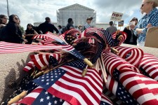 American flags are seen during a protest outside the Supreme Court over President Donald Trump's move to end birthright citizenship as the court hears arguments over the order on May 15.  Drew Angerer/AFP/Getty Images