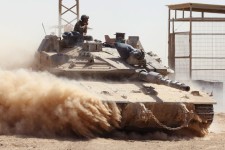 Israeli troops drive a tank near Israel’s border fence with the Gaza Strip. PHOTO: JACK GUEZ/AGENCE FRANCE-PRESSE/GETTY IMAGES